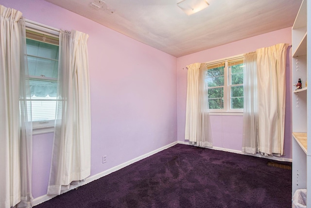 2736 Cascade Rd SE, Grand Rapids, MI 49506 - spare room featuring dark colored carpet and baseboards