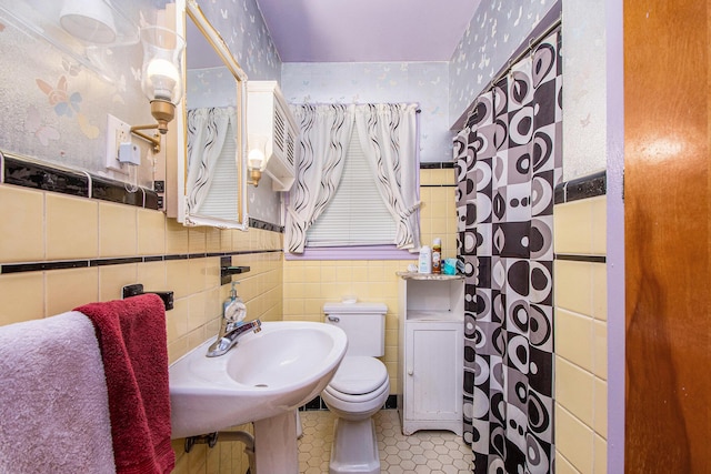 2736 Cascade Rd SE, Grand Rapids, MI 49506 - bathroom featuring wallpapered walls, tile walls, and a wainscoted wall
