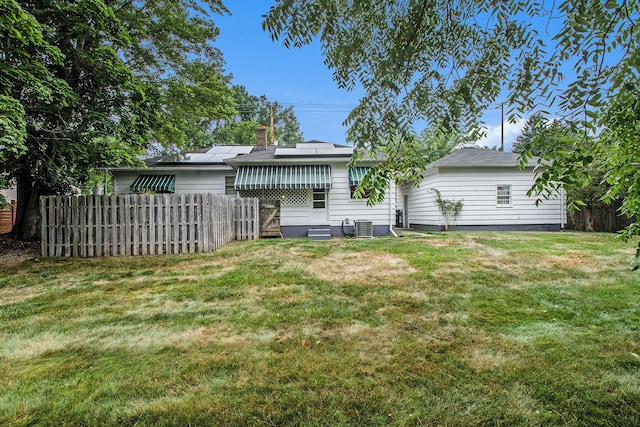 2736 Cascade Rd SE, Grand Rapids, MI 49506 - rear view of property featuring a chimney and solar panels