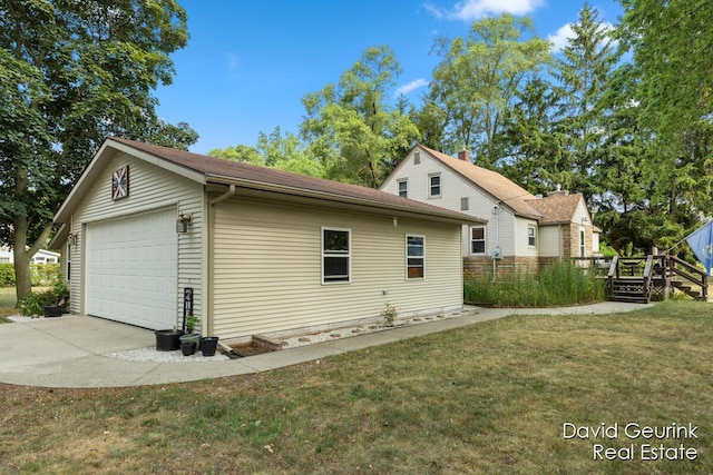 730 S 160th Ave, Holland, MI 49423 - view of home's exterior with a lawn, a wooden deck, an outbuilding, and a garage