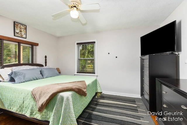 730 S 160th Ave, Holland, MI 49423 - bedroom with a ceiling fan, dark wood-type flooring, and a textured ceiling