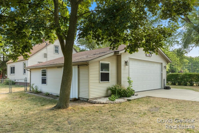 730 S 160th Ave, Holland, MI 49423 - view of side of home featuring a garage, a gate, and concrete driveway
