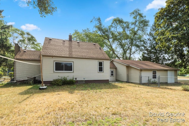 730 S 160th Ave, Holland, MI 49423 - rear view of house with a shingled roof and a chimney