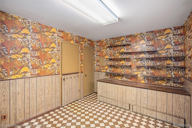 1014 Key W Dr, Clawson, MI 48017 - unfurnished dining area with wallpapered walls, wooden walls, tile patterned floors, and wainscoting