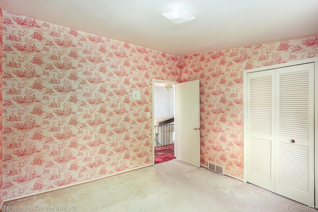 1014 Key W Dr, Clawson, MI 48017 - unfurnished bedroom featuring wallpapered walls, carpet floors, and a closet