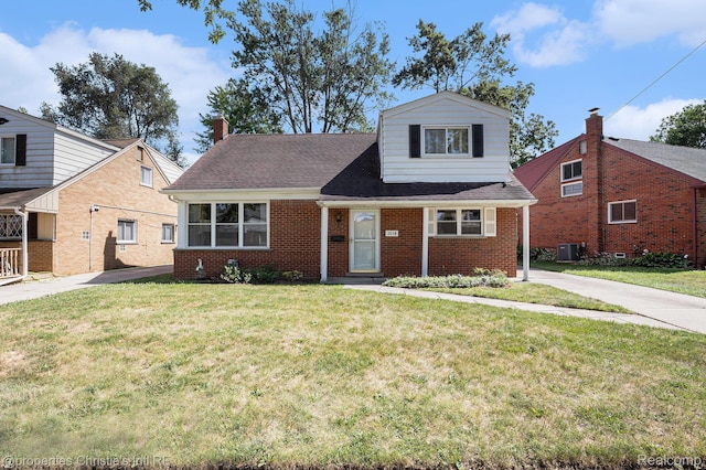 1014 Key W Dr, Clawson, MI 48017 - view of front facade with brick siding, a front lawn, a shingled roof, and a chimney