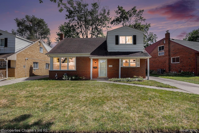 1014 Key W Dr, Clawson, MI 48017 - view of front of home with brick siding, a yard, a chimney, and a shingled roof