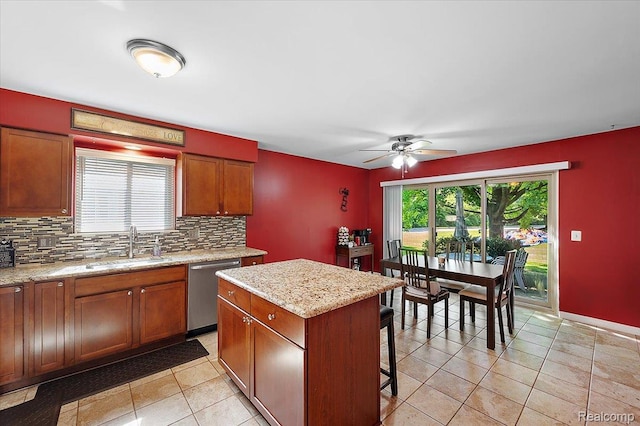 16322 Canterbury Ct, Macomb, MI 48044 - kitchen featuring stainless steel dishwasher, decorative backsplash, ceiling fan, a breakfast bar area, and light tile patterned flooring