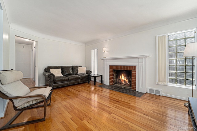 20874 Woodmont St, Harper Woods, MI 48225 - living room with wood finished floors and a brick fireplace
