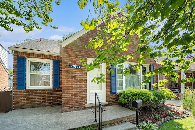 20874 Woodmont St, Harper Woods, MI 48225 - view of front facade featuring brick siding and a shingled roof