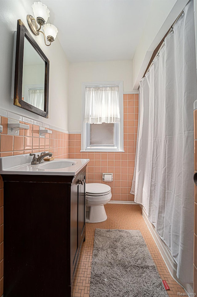 20874 Woodmont St, Harper Woods, MI 48225 - full bath with tile walls, vanity, a chandelier, a shower with shower curtain, and brick patterned floors