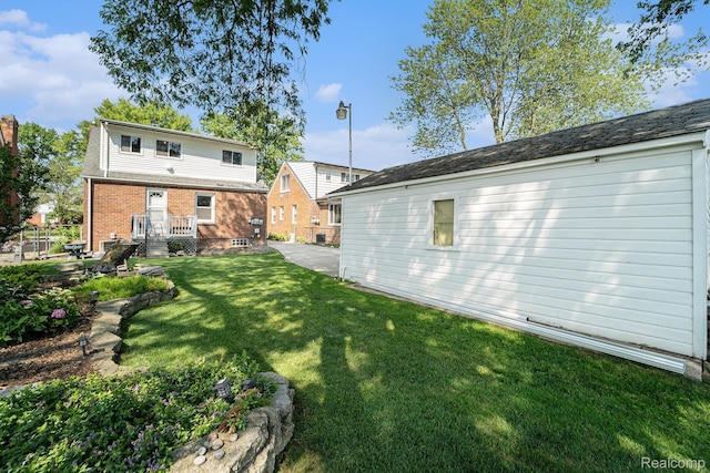 20874 Woodmont St, Harper Woods, MI 48225 - rear view of house featuring a lawn
