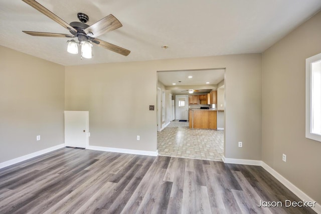 1440 College Ave NE, Grand Rapids, MI 49505 - unfurnished living room with a ceiling fan, wood finished floors, and recessed lighting