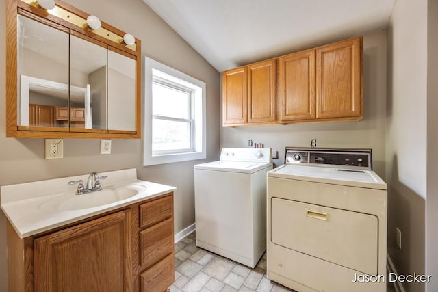1440 College Ave NE, Grand Rapids, MI 49505 - washroom with cabinet space and washing machine and dryer