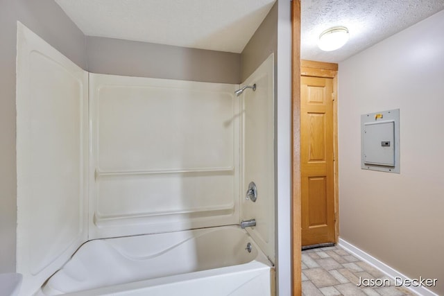 1440 College Ave NE, Grand Rapids, MI 49505 - bathroom with electric panel, tub / shower combination, and stone finish floors