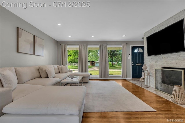 19425 Butternut Ln, Southfield, MI 48076 - living room featuring plenty of natural light, a stone fireplace, recessed lighting, and wood finished floors