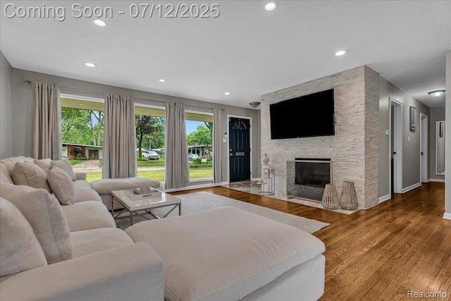19425 Butternut Ln, Southfield, MI 48076 - living area featuring healthy amount of natural light, a fireplace, wood finished floors, and recessed lighting