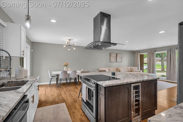 19425 Butternut Ln, Southfield, MI 48076 - kitchen with appliances with stainless steel finishes, island range hood, beverage cooler, dark brown cabinetry, and white cabinetry