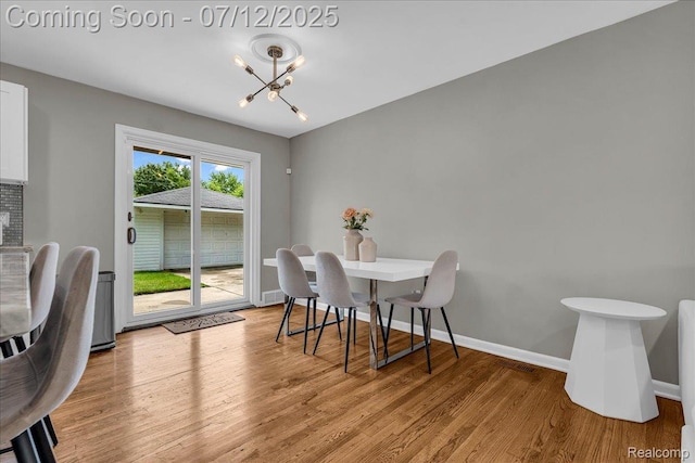 19425 Butternut Ln, Southfield, MI 48076 - dining area featuring a chandelier and light wood-style floors