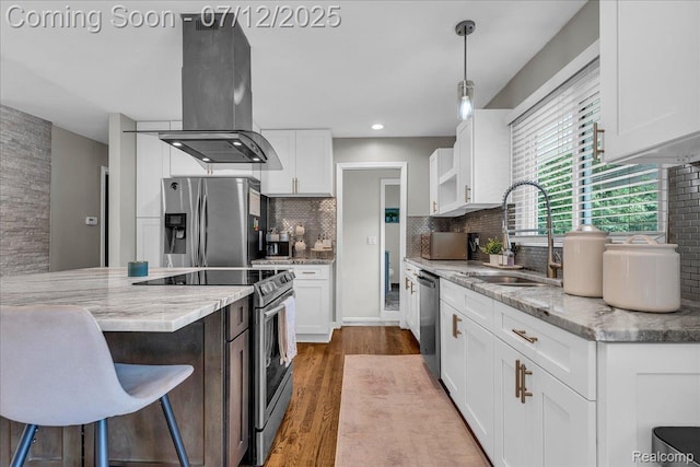 19425 Butternut Ln, Southfield, MI 48076 - kitchen featuring appliances with stainless steel finishes, island range hood, wood finished floors, white cabinetry, and recessed lighting