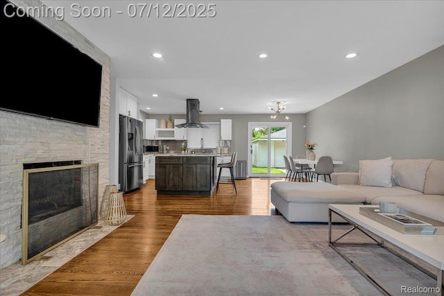 19425 Butternut Ln, Southfield, MI 48076 - living room featuring dark wood finished floors, recessed lighting, and a fireplace