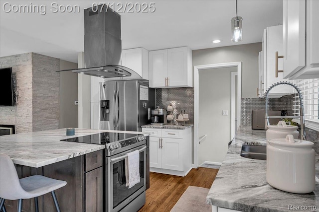 19425 Butternut Ln, Southfield, MI 48076 - kitchen featuring appliances with stainless steel finishes, island exhaust hood, decorative backsplash, white cabinets, and recessed lighting