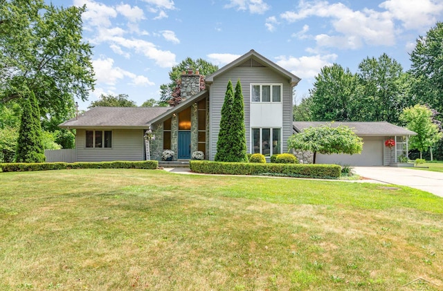 859 Foxboro Rd, Saginaw, MI 48638 - view of front of property featuring an attached garage, a chimney, concrete driveway, and a front lawn