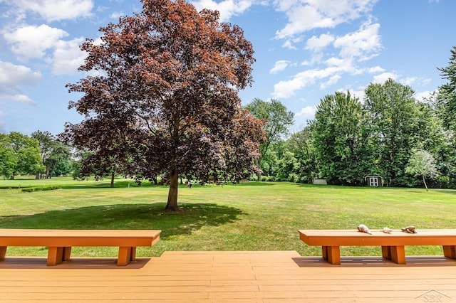 859 Foxboro Rd, Saginaw, MI 48638 - view of community with a wooden deck, a yard, and view of wooded area