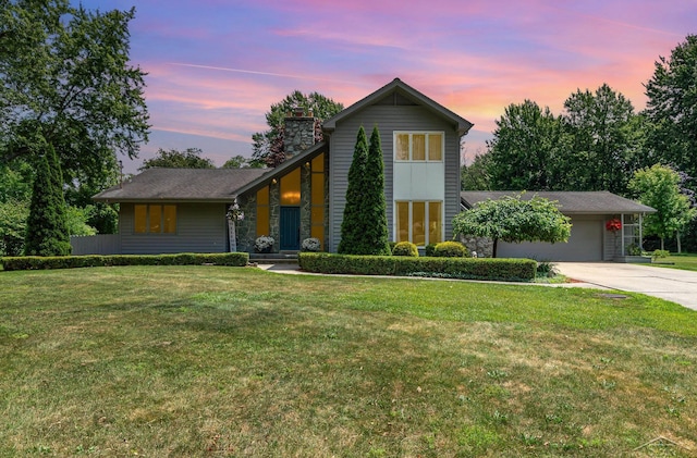 859 Foxboro Rd, Saginaw, MI 48638 - view of front of house with an attached garage, a chimney, driveway, and a front yard