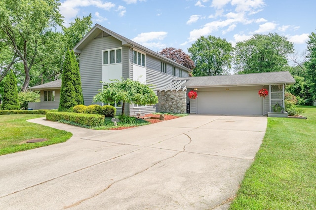 859 Foxboro Rd, Saginaw, MI 48638 - view of front facade featuring driveway, an attached garage, and a front yard