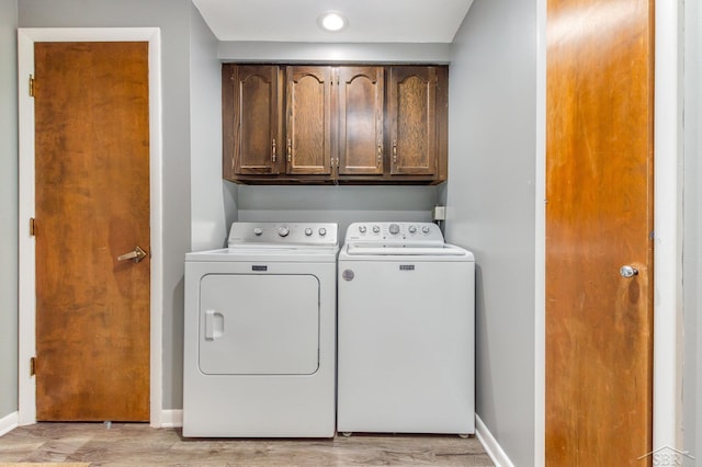 859 Foxboro Rd, Saginaw, MI 48638 - laundry room featuring washing machine and dryer, cabinet space, and light wood finished floors