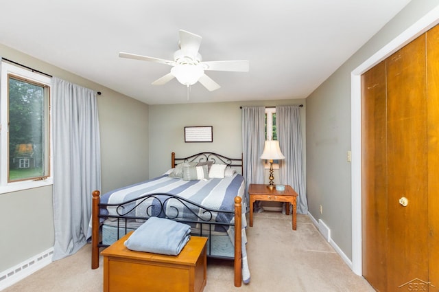 859 Foxboro Rd, Saginaw, MI 48638 - bedroom featuring light colored carpet, baseboard heating, and ceiling fan