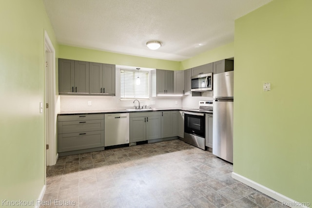 3782 Egan St, Saginaw, MI 48601 - kitchen featuring stainless steel appliances, gray cabinets, tasteful backsplash, and light countertops