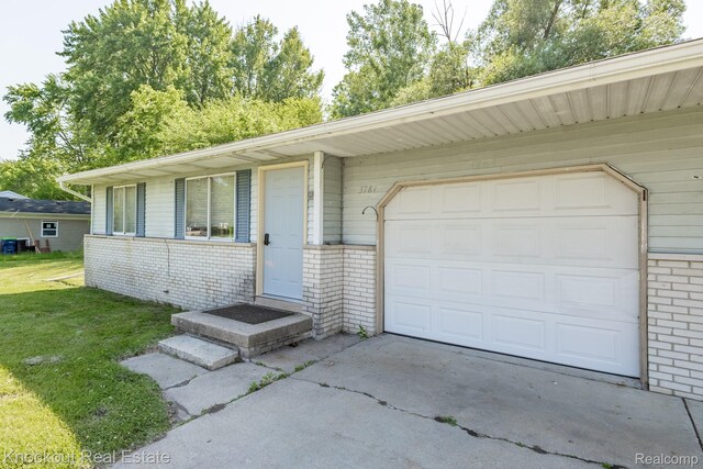 3782 Egan St, Saginaw, MI 48601 - single story home featuring brick siding, driveway, a garage, and a front lawn