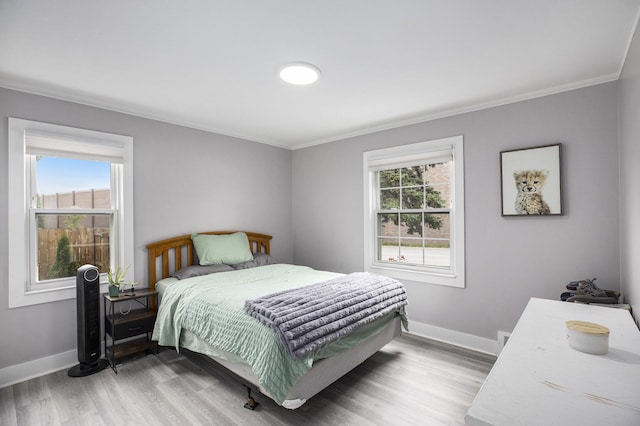 1018 S Stephenson Hwy, Royal Oak, MI 48067 - bedroom featuring ornamental molding, multiple windows, and light wood-style flooring