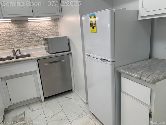 2245 S Walton Blvd Unit 58, Rochester Hills, MI 48309 - kitchen featuring freestanding refrigerator, dishwasher, light marble finish floors, decorative backsplash, and light countertops