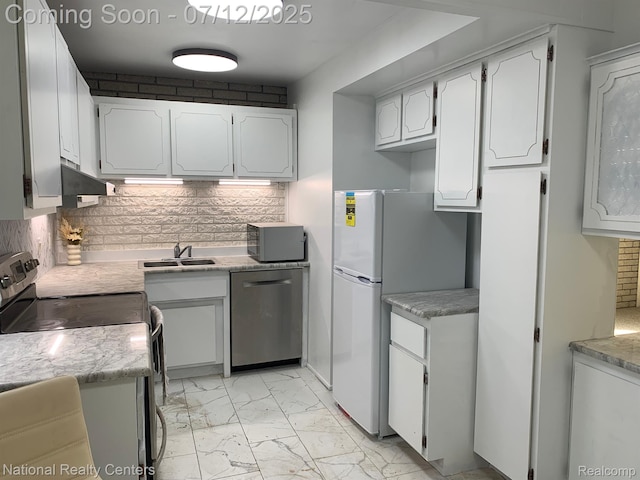 2245 S Walton Blvd Unit 58, Rochester Hills, MI 48309 - kitchen featuring stainless steel dishwasher, light marble finish floors, freestanding refrigerator, wall chimney exhaust hood, and tasteful backsplash