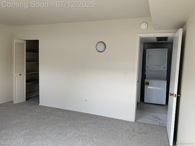 2245 S Walton Blvd Unit 58, Rochester Hills, MI 48309 - spare room with stacked washer / dryer, marble look tile flooring, and a smoke detector