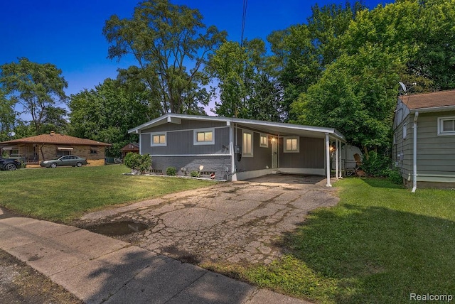 3818 Wisner St, Flint, MI 48504 - view of front of home featuring driveway, a front yard, and a carport
