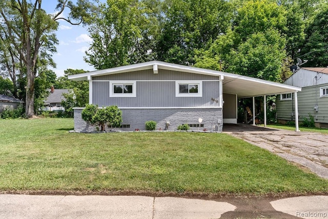3818 Wisner St, Flint, MI 48504 - view of front facade featuring a front yard, asphalt driveway, an attached carport, and brick siding