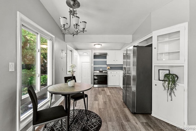 3818 Wisner St, Flint, MI 48504 - dining space with a chandelier and dark wood-style flooring