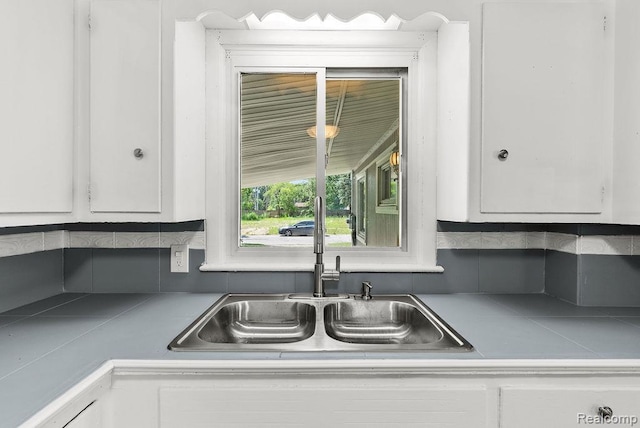 3818 Wisner St, Flint, MI 48504 - kitchen with white cabinetry and backsplash