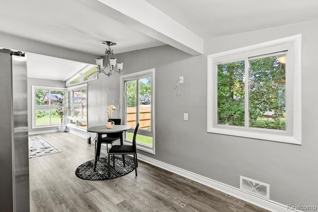 3818 Wisner St, Flint, MI 48504 - dining space with a chandelier, wood finished floors, and healthy amount of natural light