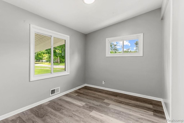 3818 Wisner St, Flint, MI 48504 - empty room with dark wood-style flooring and vaulted ceiling