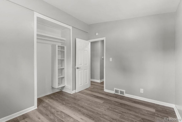 3818 Wisner St, Flint, MI 48504 - unfurnished bedroom with wood finished floors and a closet