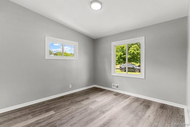 3818 Wisner St, Flint, MI 48504 - empty room featuring wood finished floors and lofted ceiling