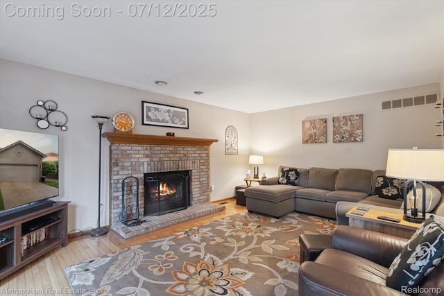 2129 Camelot Dr, Troy, MI 48083 - living area featuring wood finished floors and a brick fireplace