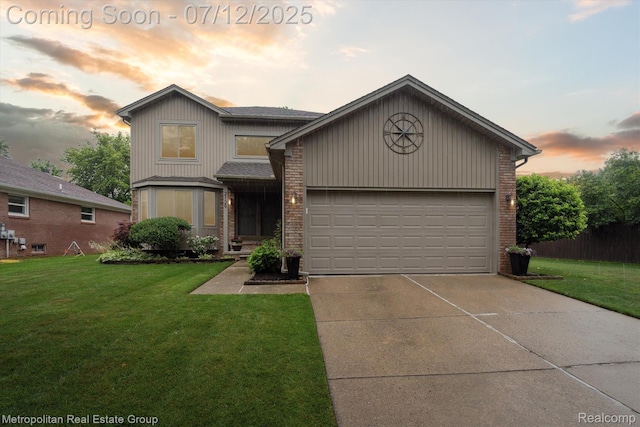 2129 Camelot Dr, Troy, MI 48083 - view of front facade featuring brick siding, driveway, a front yard, and a garage