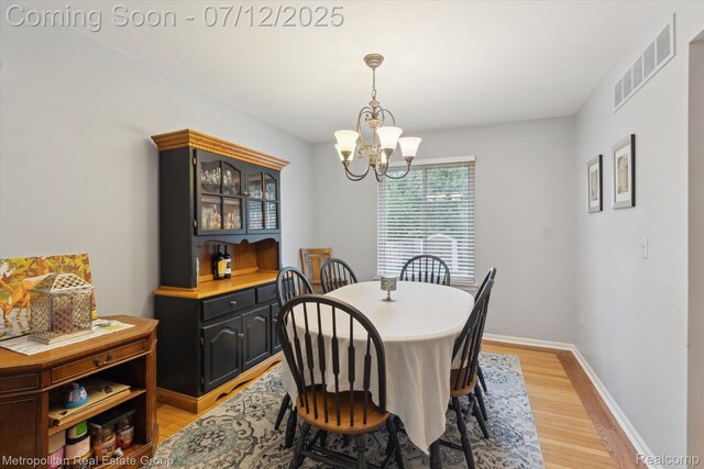 2129 Camelot Dr, Troy, MI 48083 - dining space featuring a chandelier and light wood-style flooring