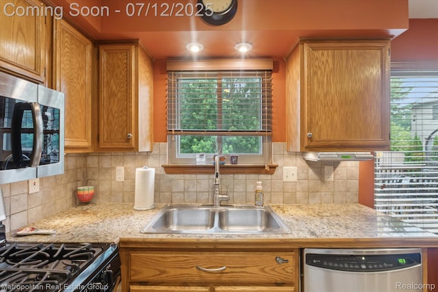 2129 Camelot Dr, Troy, MI 48083 - kitchen featuring appliances with stainless steel finishes, brown cabinetry, decorative backsplash, and healthy amount of natural light